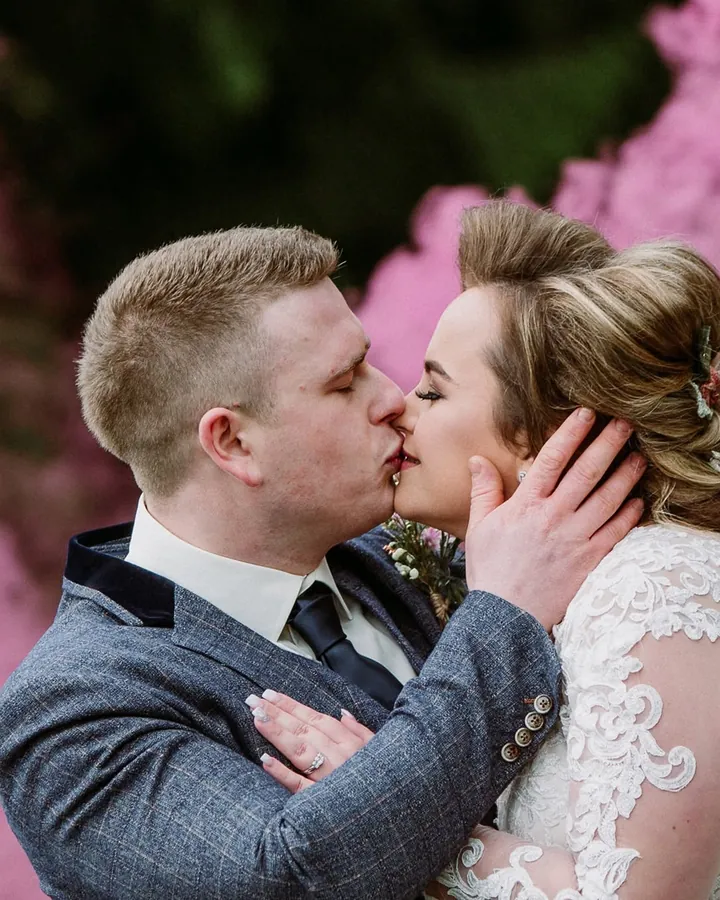 Bride and groom with pink smoke